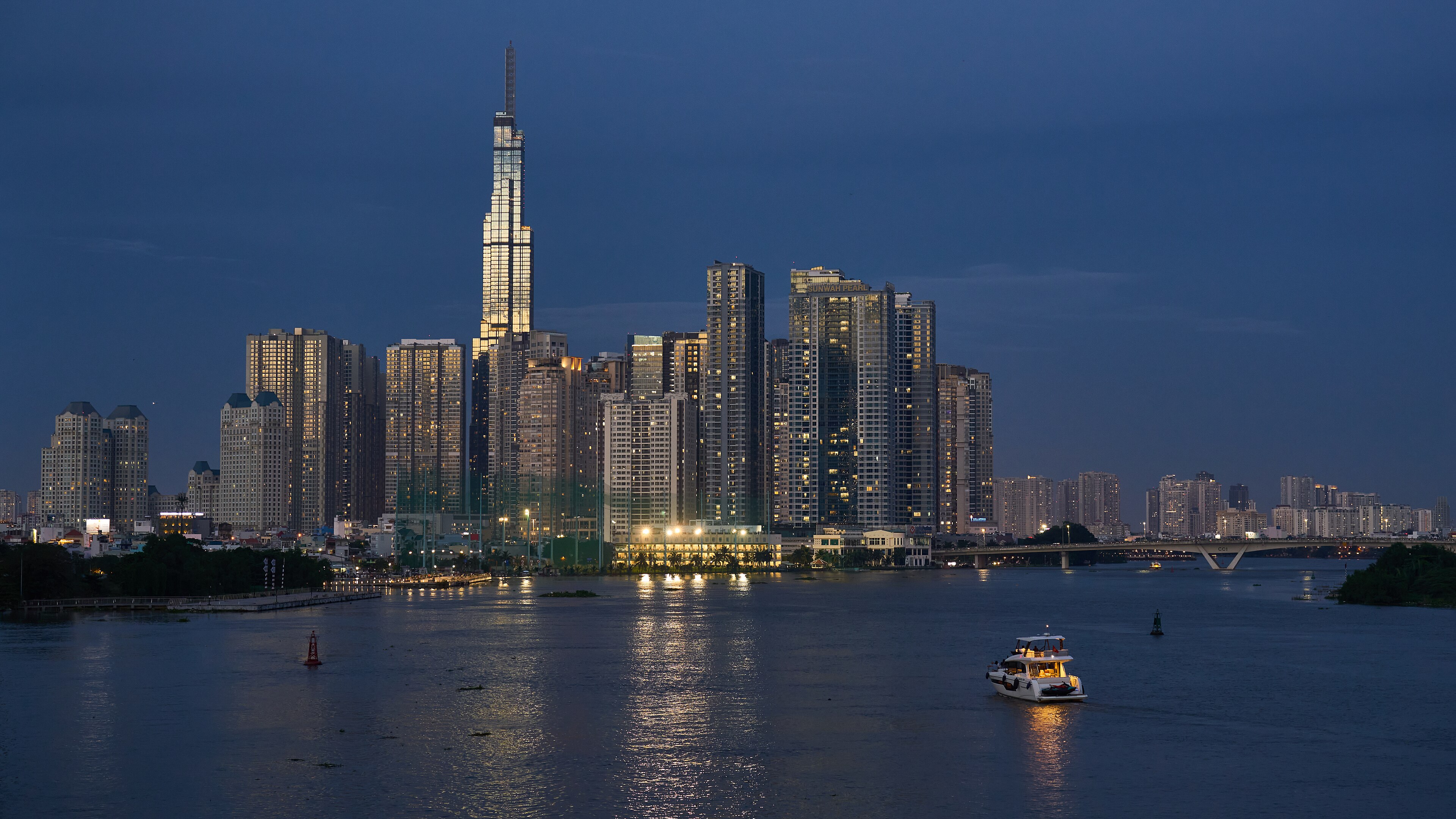 The Saigon River and illuminated skyline at blue hour